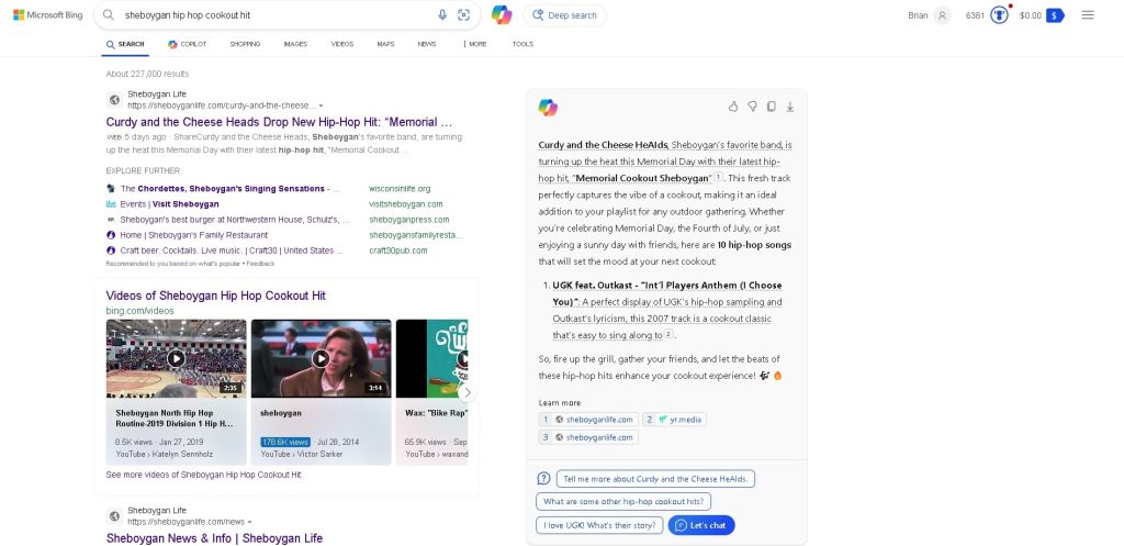 Screenshot of Bing search results for 'sheboygan hip hop cookout hit.' The top result is an article from Sheboygan Life about Curdy and the Cheese Heads' new hip-hop hit, with additional related links and video content. Bing's results also feature options to learn more about related topics and ask questions about the band.