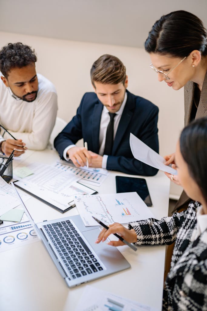 Diverse team engaged in reviewing documents during a business meeting.